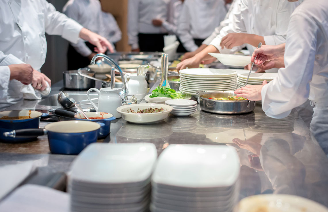 chefs preparing meals in kitchen