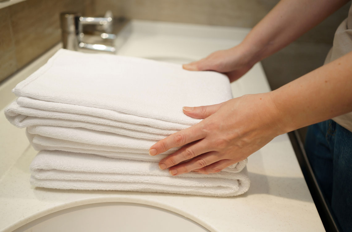 folded towels on sink