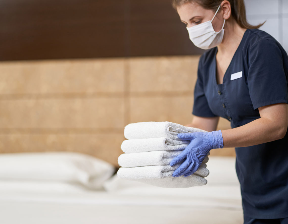 person holding folded towels