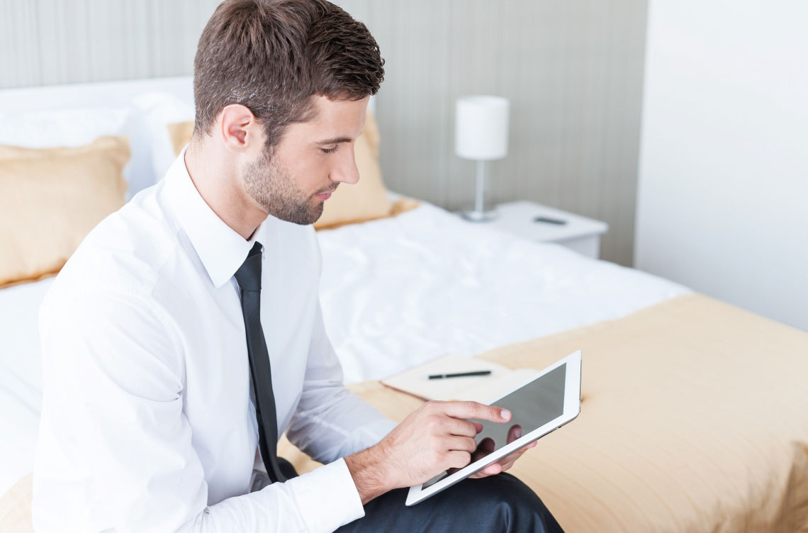 person using tablet in bed